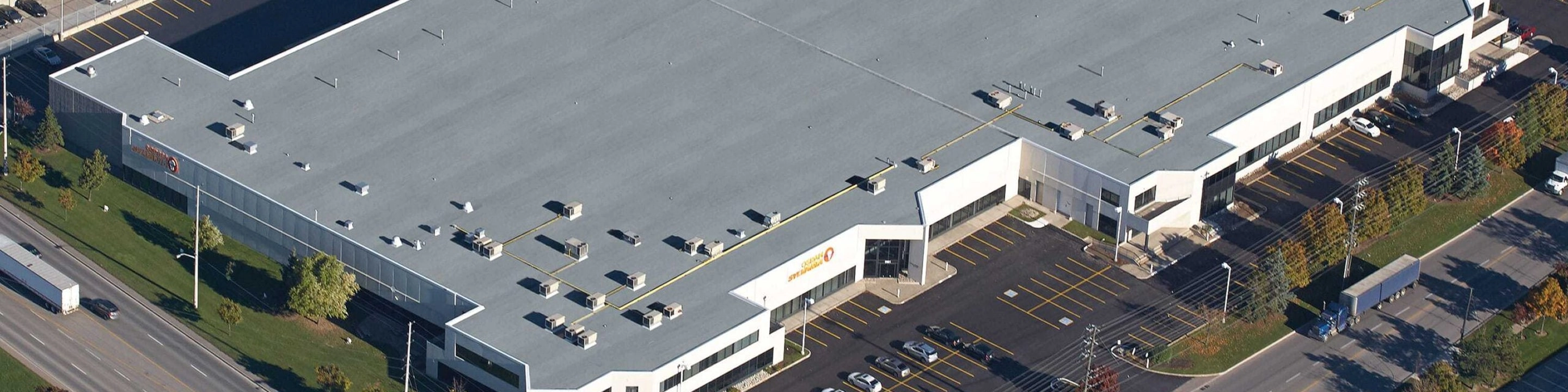 The Osram Sylvania, Inc. facility, a large white building with a flat grey roof.