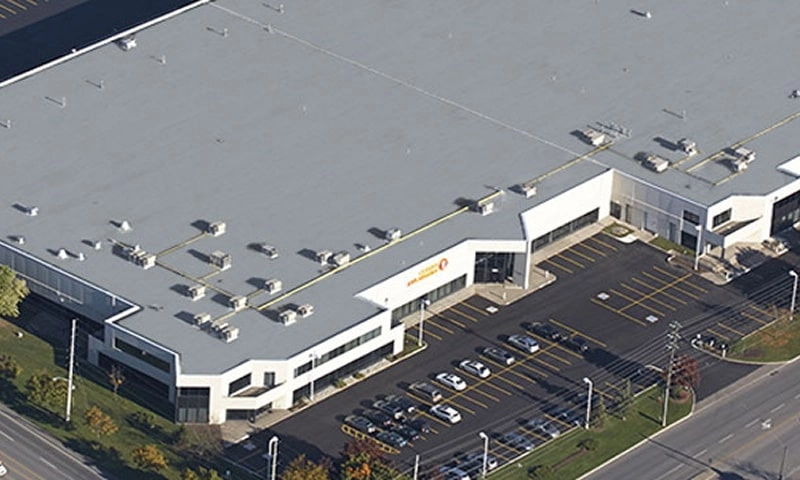 The Osram Sylvania, Inc. facility, a large white building with a flat grey roof.