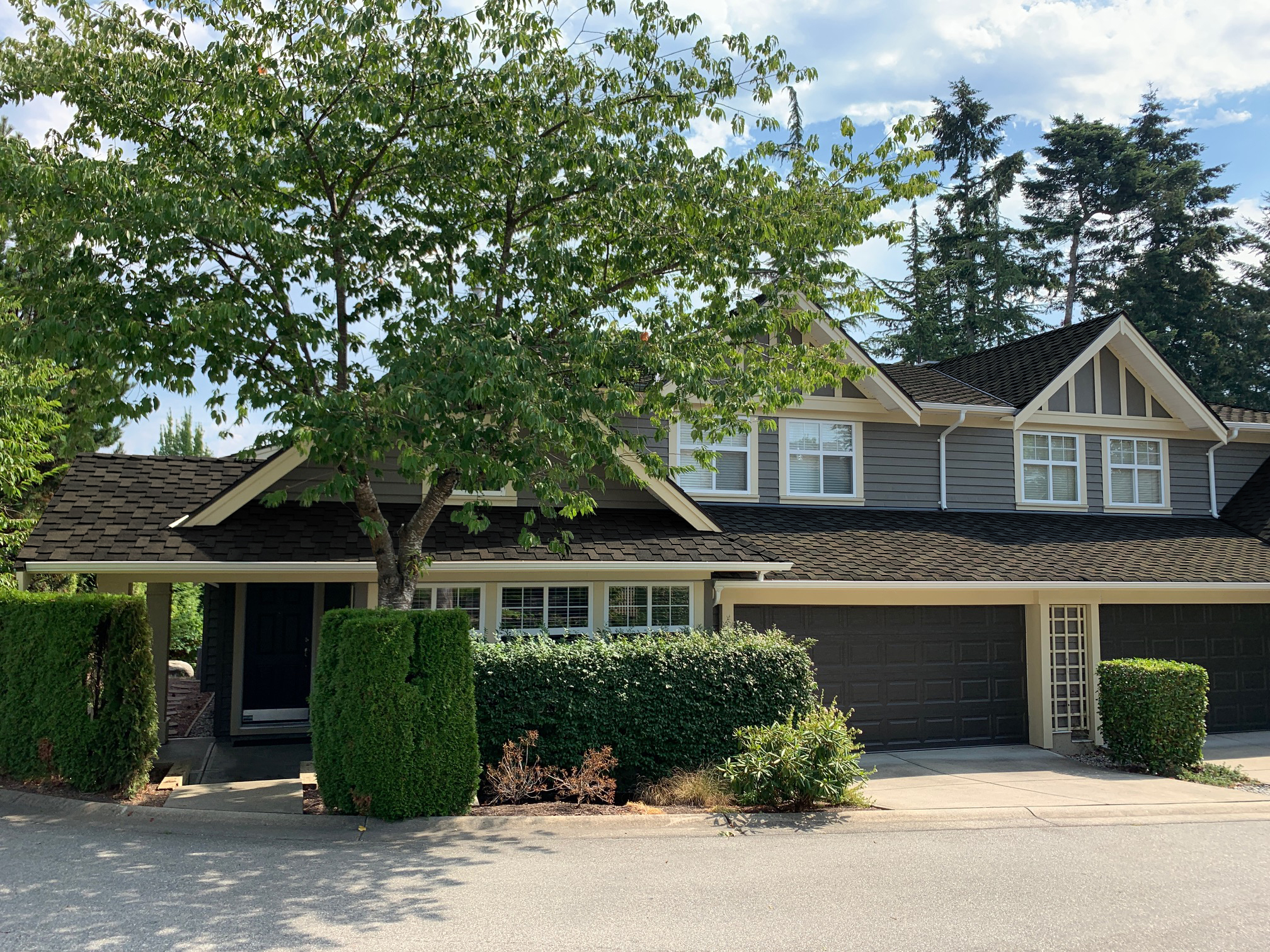 A home with a dark brown roof of IKO shingles.