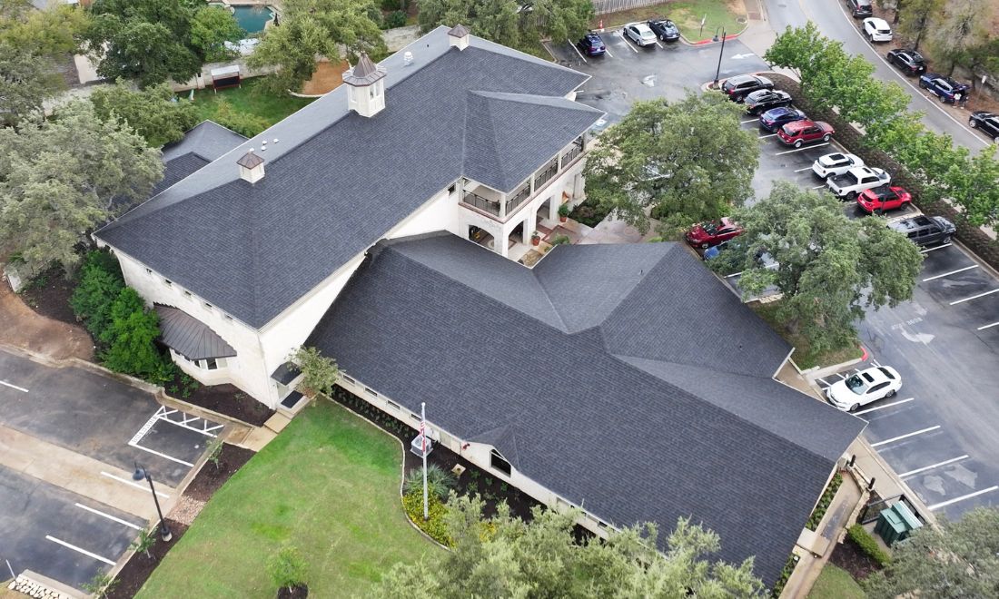 Aerial view of the West Bank Community Library in Austin, Texas, featuring a newly installed IKO® Dynasty® performance shingle roof in the color Glacier.